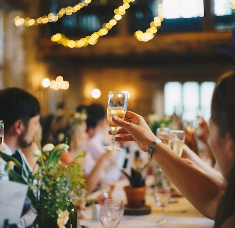 toasting a wedding, blurry background of people