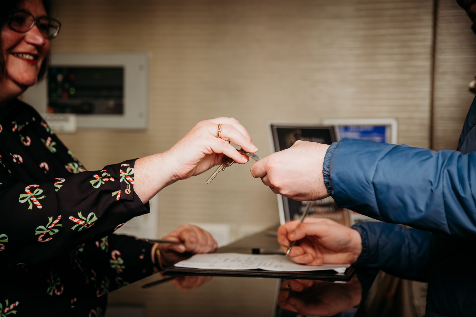 Red Hall Hotel staff handing over room keys from reception