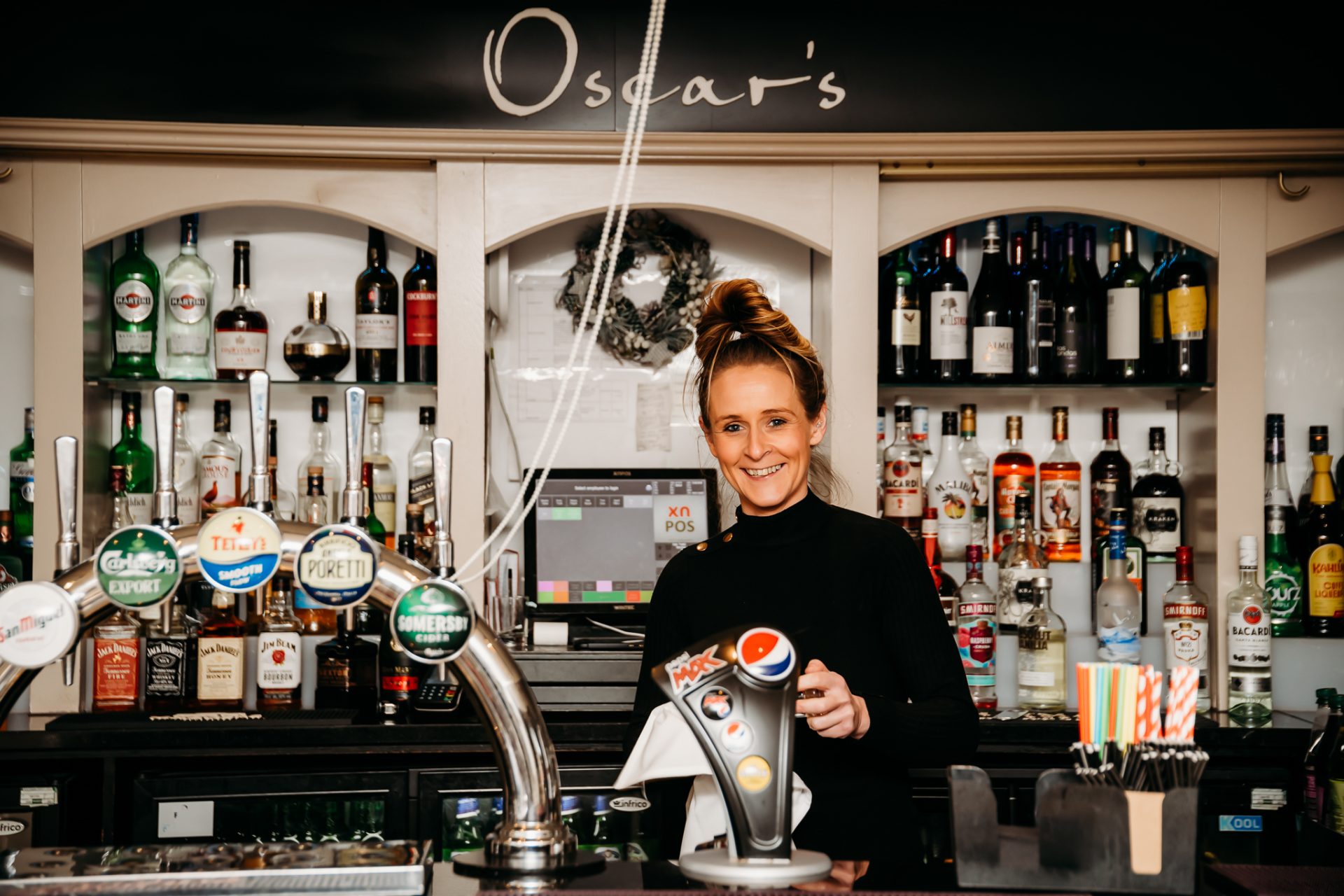 Red Hall Hotel bartender smiling behind the bar