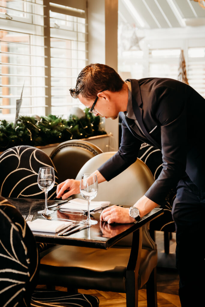 Red Hall Hotel staff setting a table